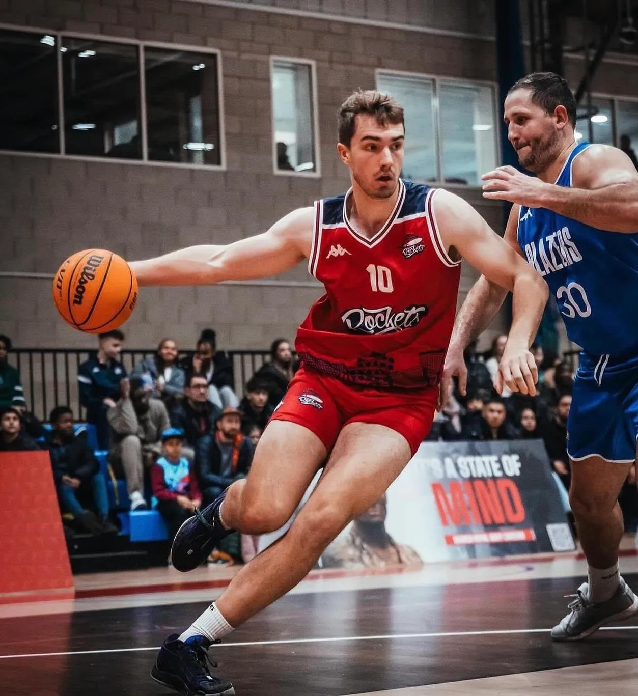 Ben Tew driving past a defender